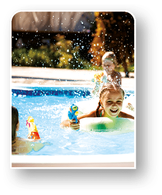 Cheerful children playing waterguns, rejoicing, jumping, swimming in pool. Copy space